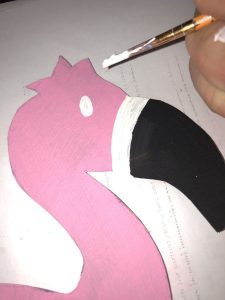 Paint the white parts of the DIY Flamingo Centerpiece