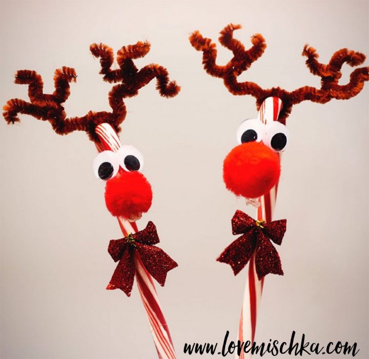 Two Reindeer Candy Canes with big red pom poms as noses, googly eyes, and brown pipe cleaner twisted into antlers.