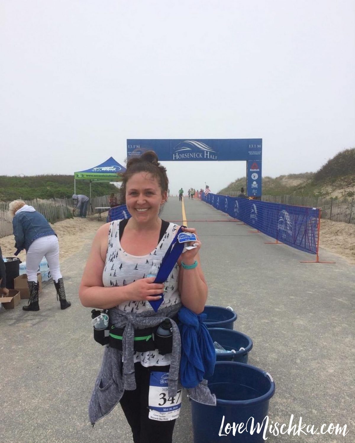 Me holding my medal at the finish line of the Horseneck Half Marathan after I finished it for the first time ever!