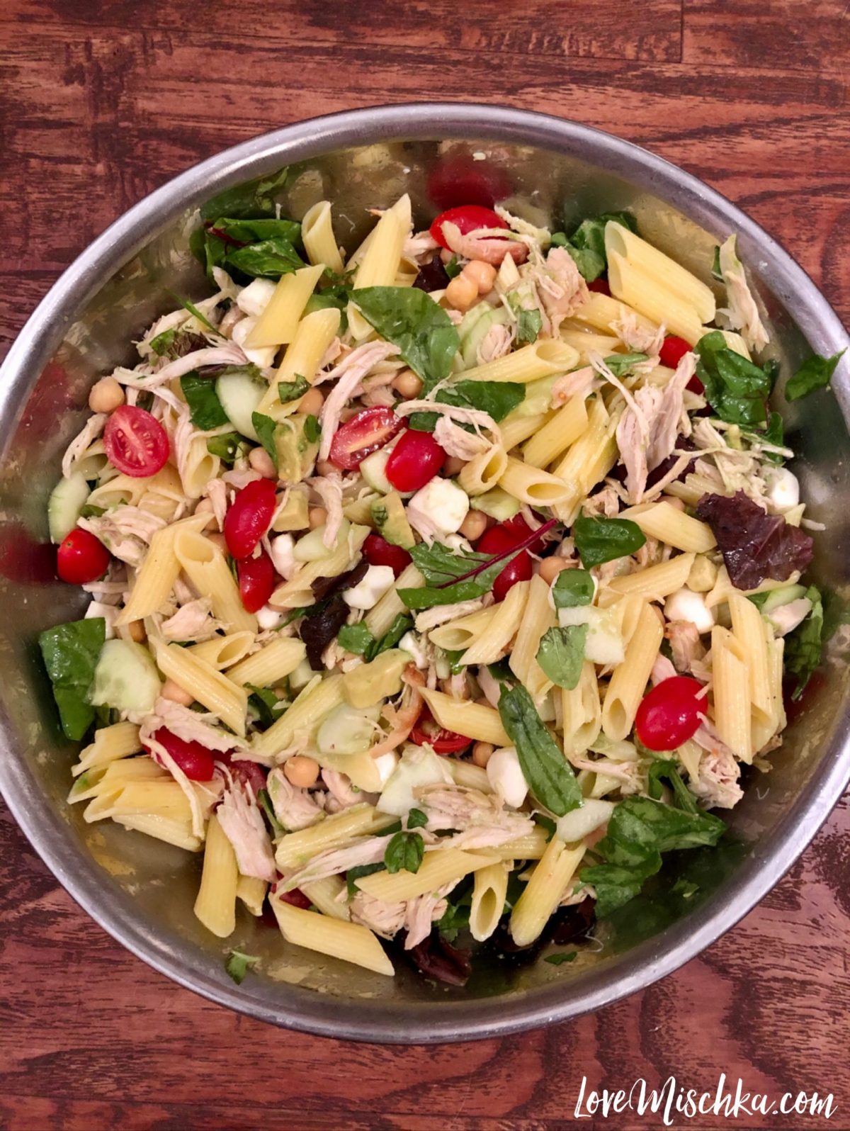 A big bowl of high protein pasta salad - chicken, mozzarella, chickpeas with pasta and veggies