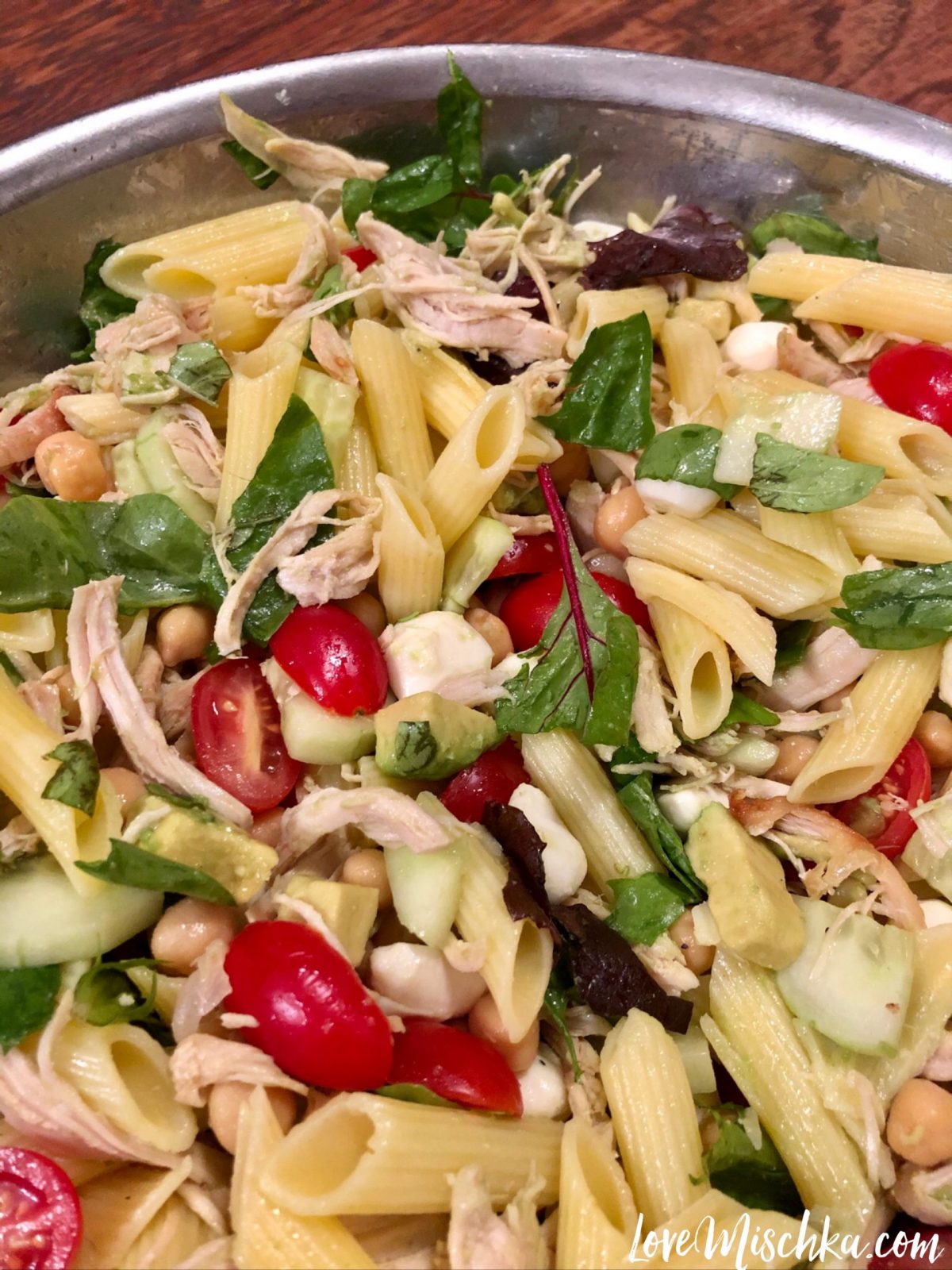 A close up of high protein pasta salad with vegetables