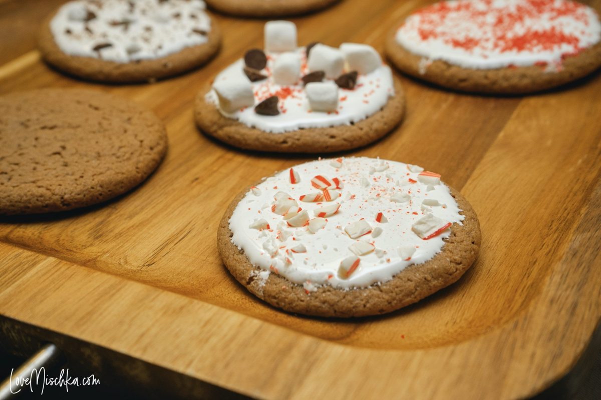 Hot Cocoa Cookies with Marshmallow Icing and Candy Cane pieces of a serving tray