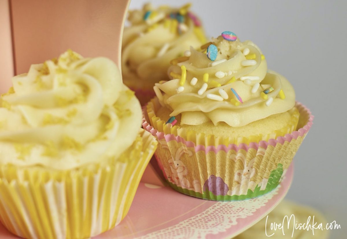 Easy Lemon Cupcakes from Scratch are displayed on a pink cupcake stand,