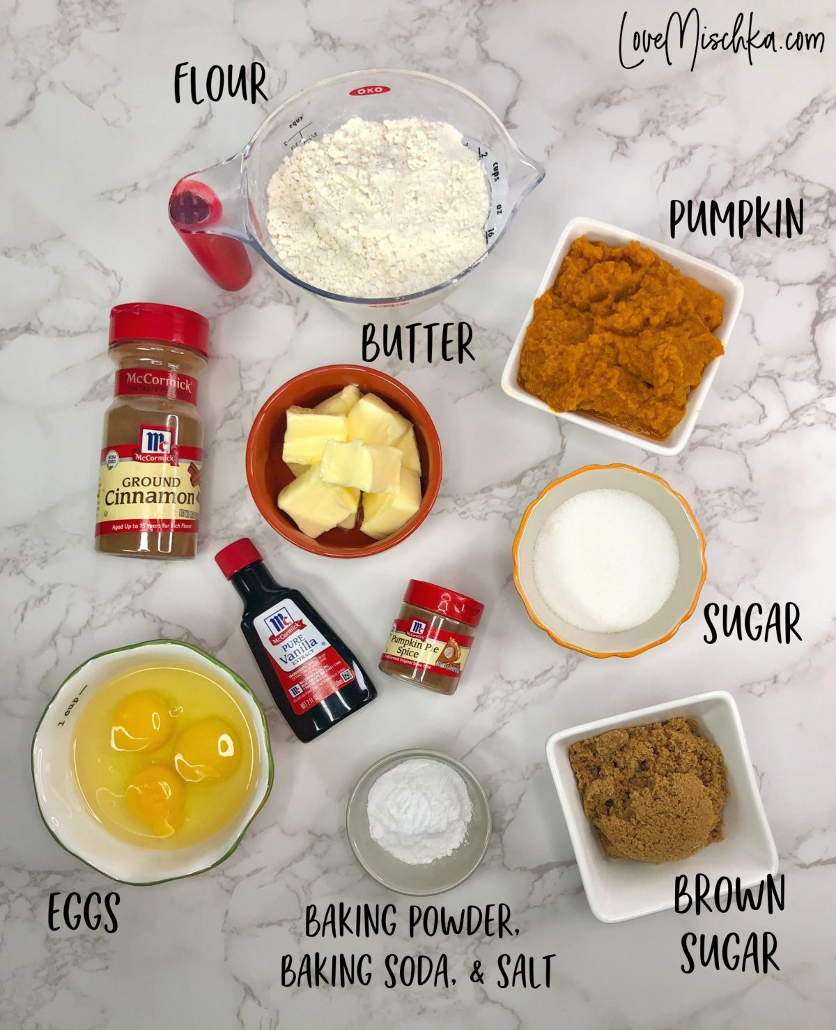 Ingredients for Pumpkin Cake laid out on a marble table.