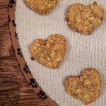 Heart-shaped, homemade dog treats made with only three ingredients - banana, peanut butter, and oats.