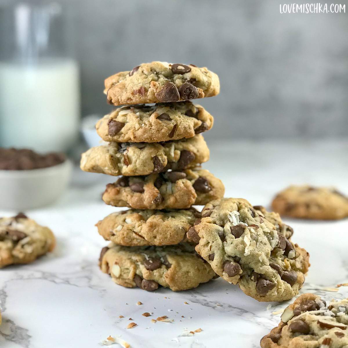 Almond Joy Cookies are stacked and laying on a marble counter top in this Almond Joy Cookie Recipe.