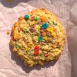 A golden cookie with bright, rainbow fruity pebbles cereal