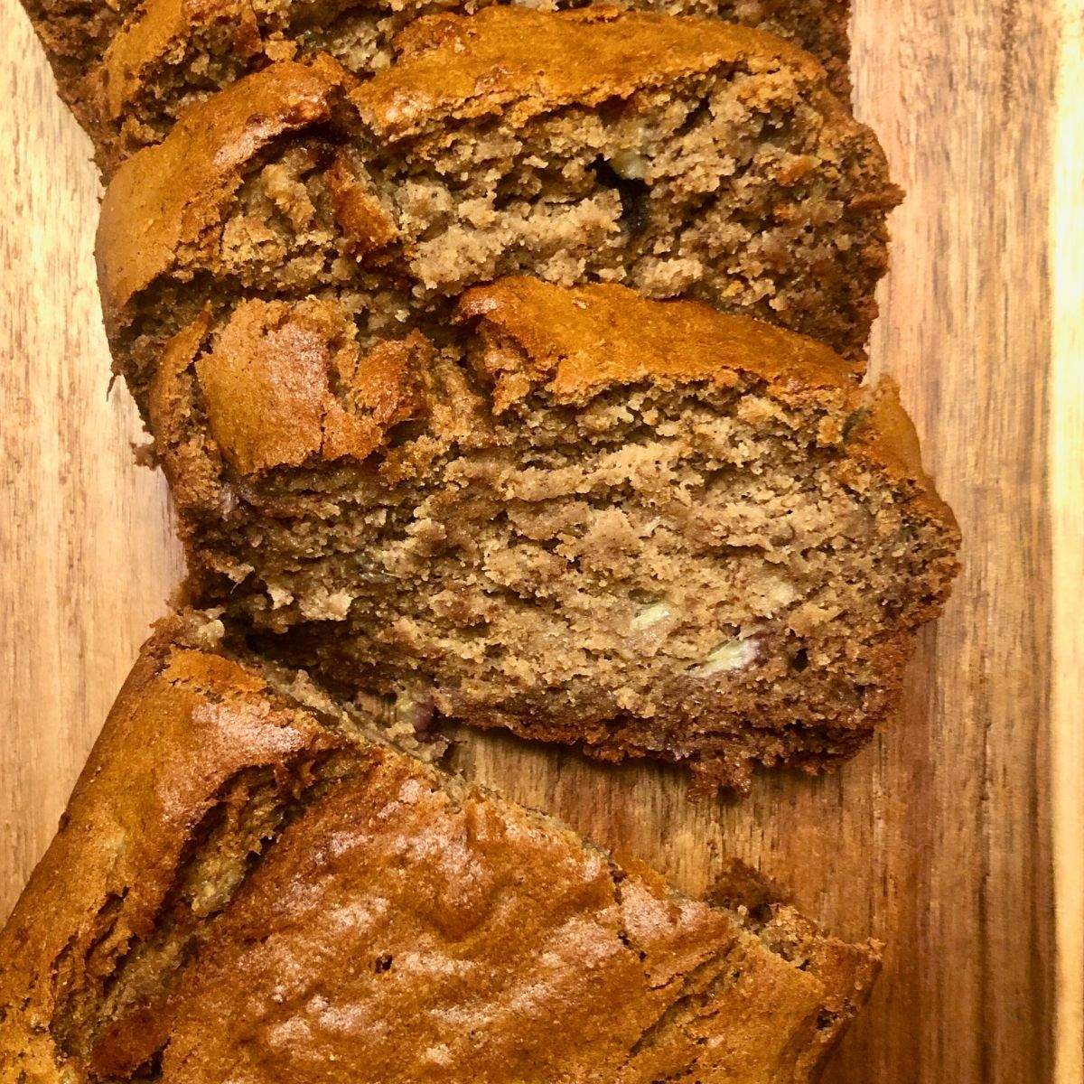 A close-up of sliced, golden brown gluten-free banana bread.