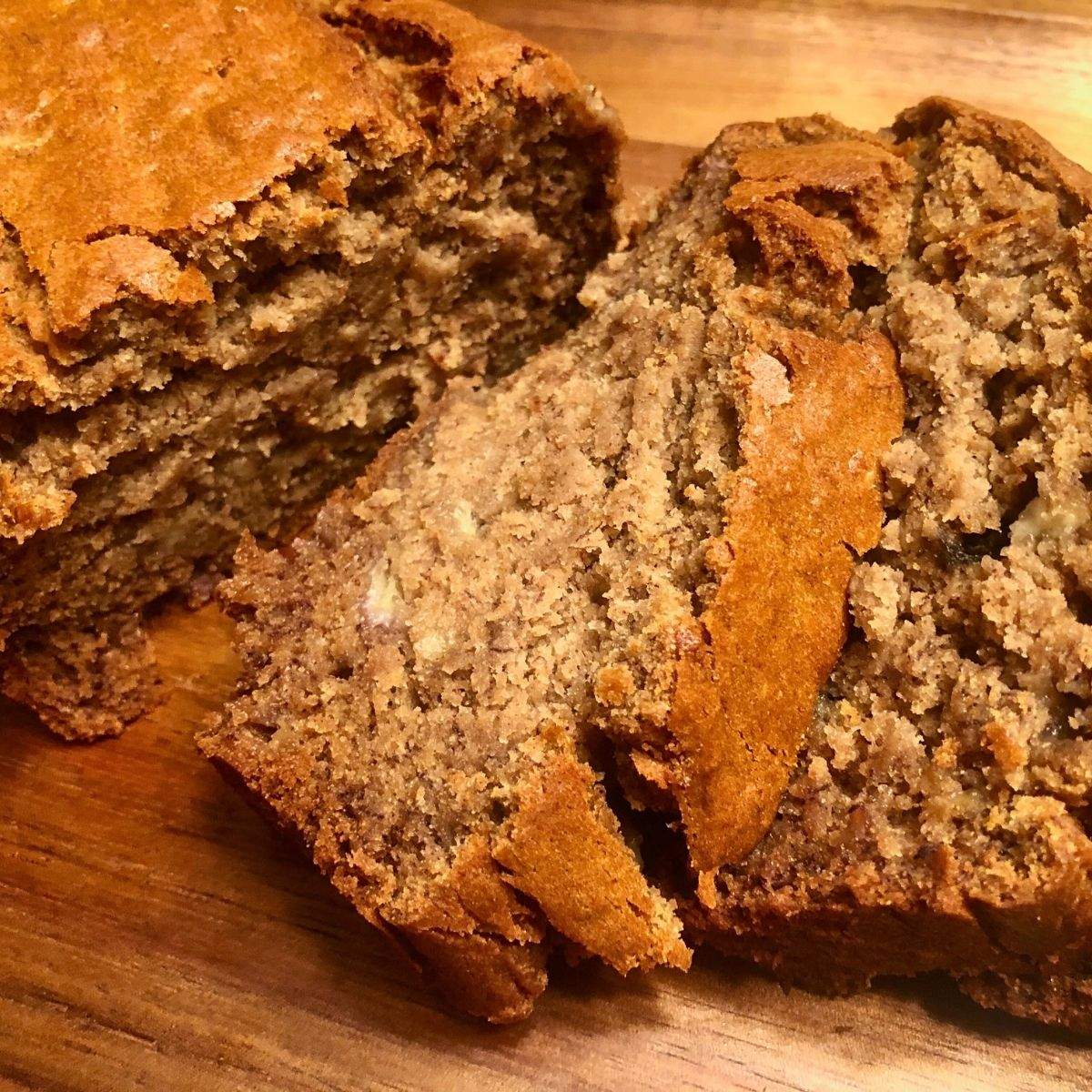 A close-up of sliced, golden brown, soft, moist banana bread (gluten free) pieces.